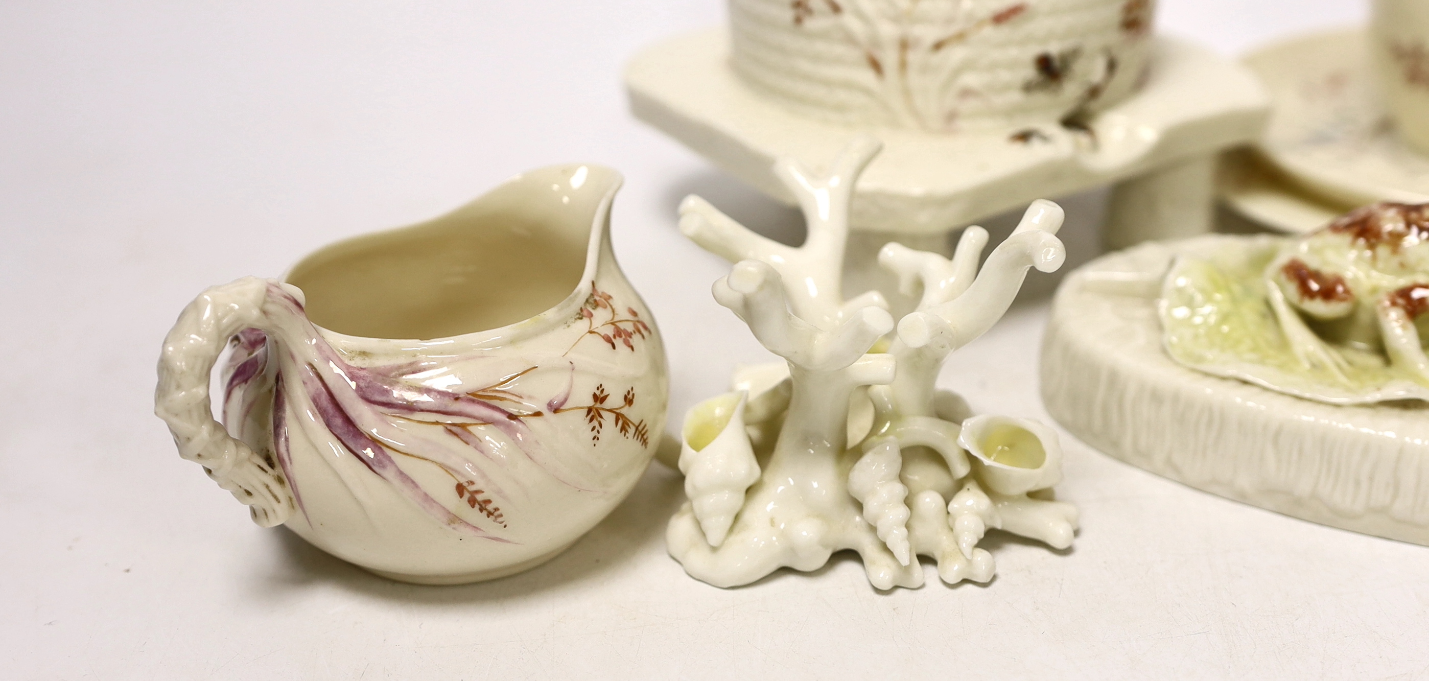 A small quantity of 1st and 2nd period Belleek including a ‘frog’ paperweight and a ‘beehive’ honey jar together with a related reference book by Marion Langham